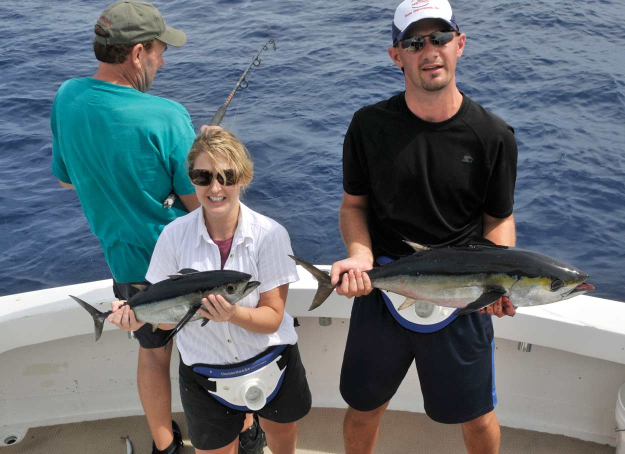 Greg and Sheila with their tuna in the boat while Paul still fights his.