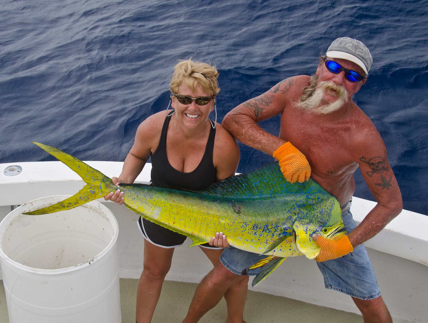 Lynn Bundy lands the biggest dolphin of their fishing trips in the Keys.