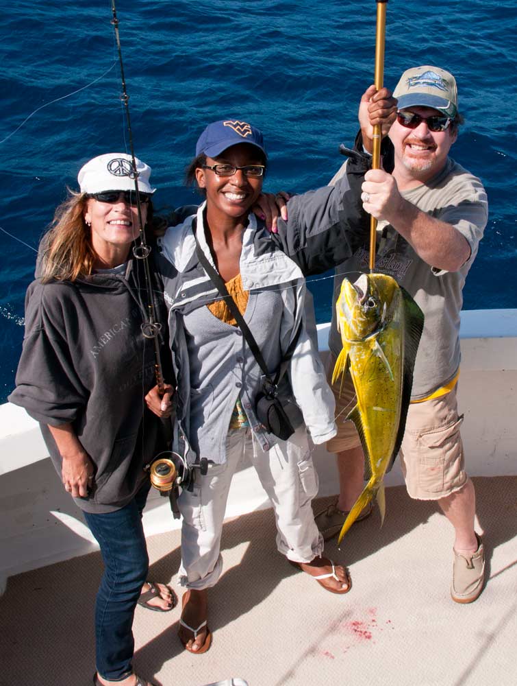 Norelle Morris (center) caught her first dolphin with moral support from Lon and Nancy.
